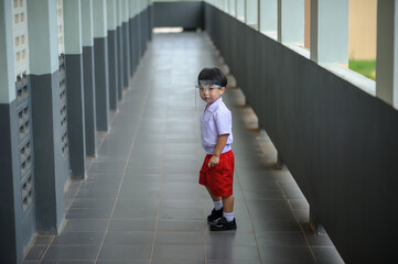 Cute preschooler child wearing face shield at school during covid-19 epidemic,New normal lifestyle in public places.