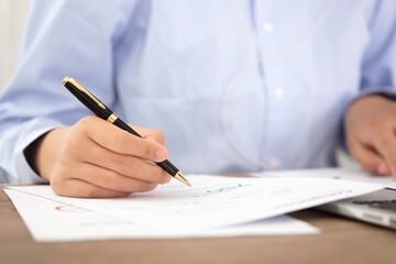Close-up shot of a pen while viewing documents