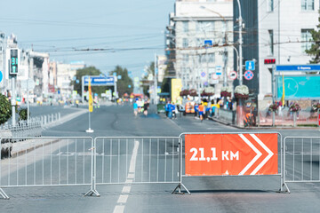 Red signpost 21.1 km sign to guide runners during the half marathon on the street