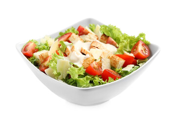 Delicious fresh Caesar salad in bowl on white background
