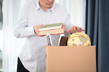 The laid-off employee packs up personal belongings