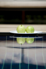 apples on plate in swimming pool