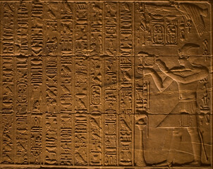 Hieroglyphics in Phile temple, Egypt. Ancient carved writing from a historic tomb in the middle east.