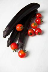 eggplant and cherry tomato on table
