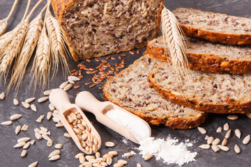 Wholegrain bread, ingredients for baking and ears of rye or wheat grain