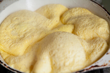 Appetizing omelette in frying pan