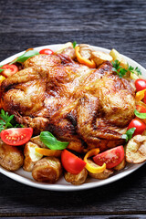 roast chicken served with vegetables on a platter