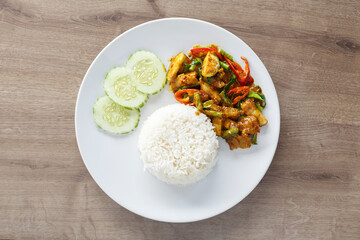 Top view Thai curry with steamed rice on white dish.