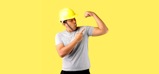 Asian man Industry worker or engineer working an architect builder Pointing finger isolated on yellow background in studio With copy space.