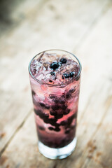 Summer cocktail with lot of bilberries. Shallow depth of field. 
