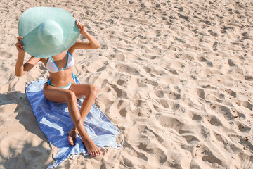 Fototapeta na wymiar Beautiful young woman in swimsuit on sea beach