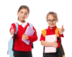 Little pupils showing thumb-up on white background