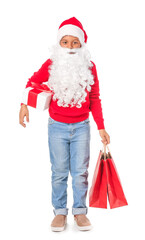 Cute African-American boy in Santa costume and with shopping bags on white background