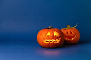 Carved Halloween pumpkins on color background