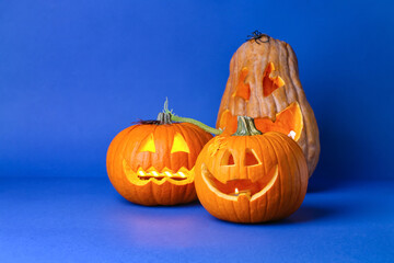 Carved Halloween pumpkins on color background