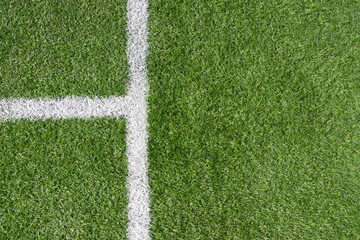 Green artificial grass turf soccer football field background with white line boundary. Top view