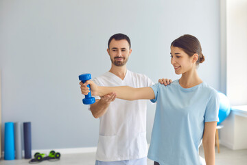 Doctor teaching young woman to do osteoporosis treatment exercise with dumbbells