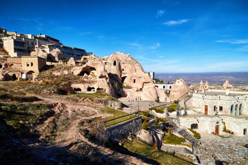 Fototapeta premium View on Cappadocia rock houses, caves and ruins in Goreme in Anatolia, Turkey. Ruins of an ancient city. The concept of the historic voyage