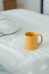Fototapeta na wymiar Morning coffee mug in bed