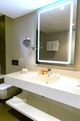 Modern bathroom interior with illuminated mirrors