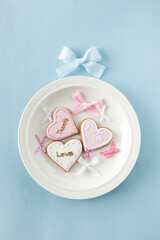 Fototapeta na wymiar heart shaped icing cookies and ribbon