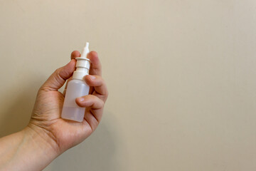 Hand holding nose spray