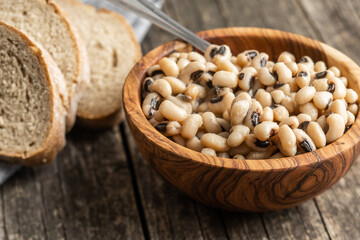 Marinated black eyed beans in wooden bowl.