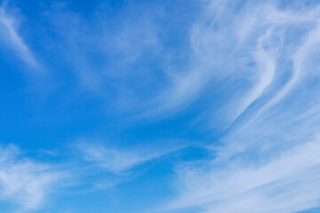 Blue sky background with white cirrus clouds