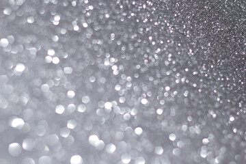 silver and white bokeh lights defocused. glitter abstract background