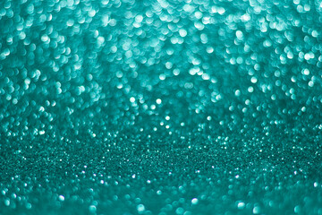 Obraz premium green and blue sparkle glitters with bokeh effect and selectieve focus. Festive background with bright gold lights, champagne bubble. Christmas mood concept. Copy space, close up, texture, top view.