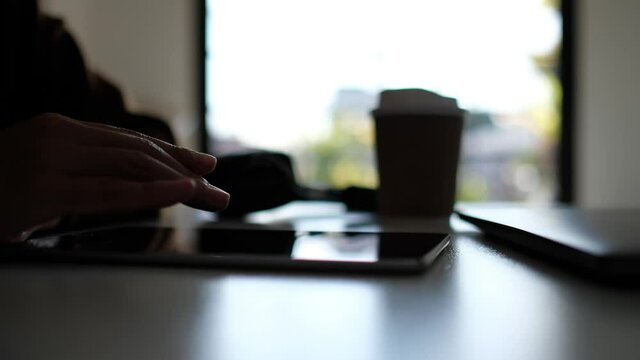 A woman using and touching on tablet pc screen