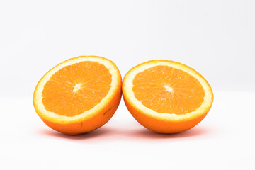 Two halves of orange on white background