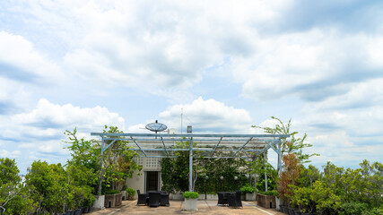 rooftop garden with satellite dishes in sky background