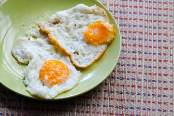 two fried eggs on a plate