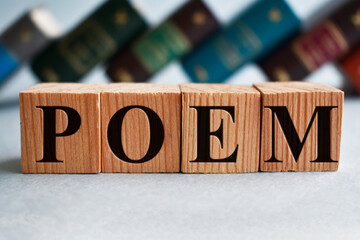 poem writing on wooden cubes and books on the background