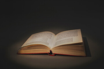 concept of wisdom and knowledge, open book that lights up