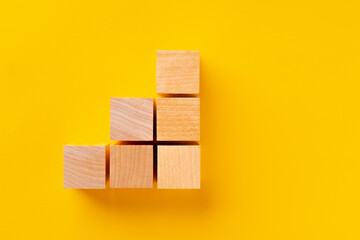 Top view of wooden cubes on yellow