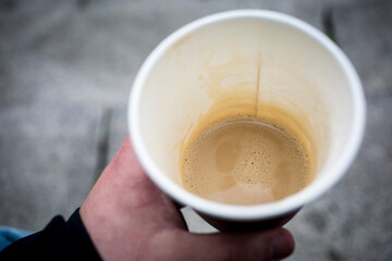 Person drinking a cup of coffee in the city
