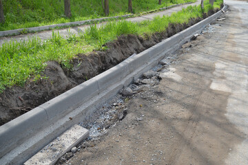 Replacing the curb on the city road. Installed new curbs, filled with cement. Arrangement of the city. Selective Focus.