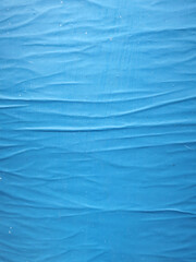 blue colored glued paper forming a pattern of waves