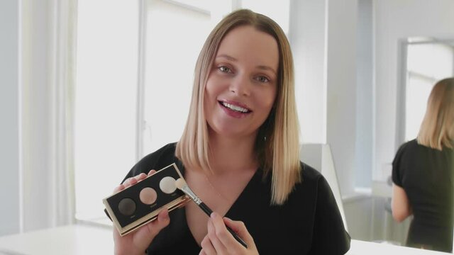 Young beautiful woman professional beauty vlogger or blogger recording make up tutorial to share on social media