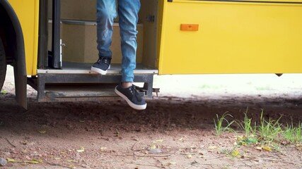 Kid coming out from the School bus with medical mask wearing while maintaining social distancing as coronavius or covid-19 safety measures - concept of back to school and school reopen - Powered by Adobe