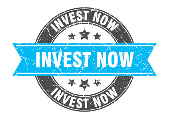 invest now round stamp with ribbon. label sign