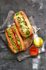 Hot dogs with various fillings. Dark background. food background with copy space. Top view. Hot...