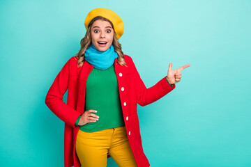 Astonished positive girl point index finger copyspace impressed incredible ads promotion scream wow omg indicate present wear headwear pants trousers isolated over teal color background