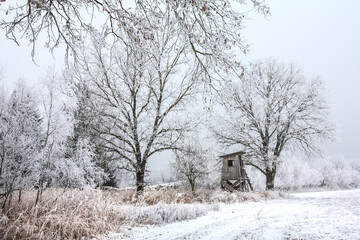 Jagd Kanzel im Winter mit schneebedeckten kahlen Bäumen