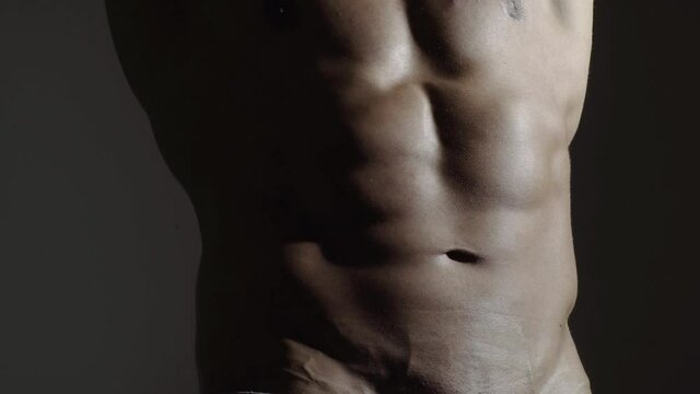 Muscular mens abdomen, strong abs, six pack. Sexy man with bare torso.