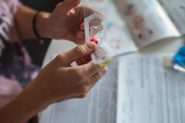 Process of coronavirus testing examination at home, COVID-19 swab collection kit, test tube for taking OP NP patient specimen sample, testing carried out, patient receiving a corona test