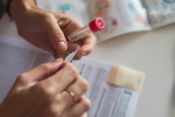 Process of coronavirus testing examination at home, COVID-19 swab collection kit, test tube for taking OP NP patient specimen sample, testing carried out, patient receiving a corona test