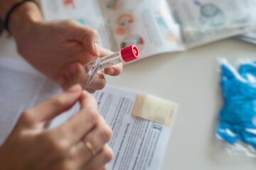 Process of coronavirus testing examination at home, COVID-19 swab collection kit, test tube for...